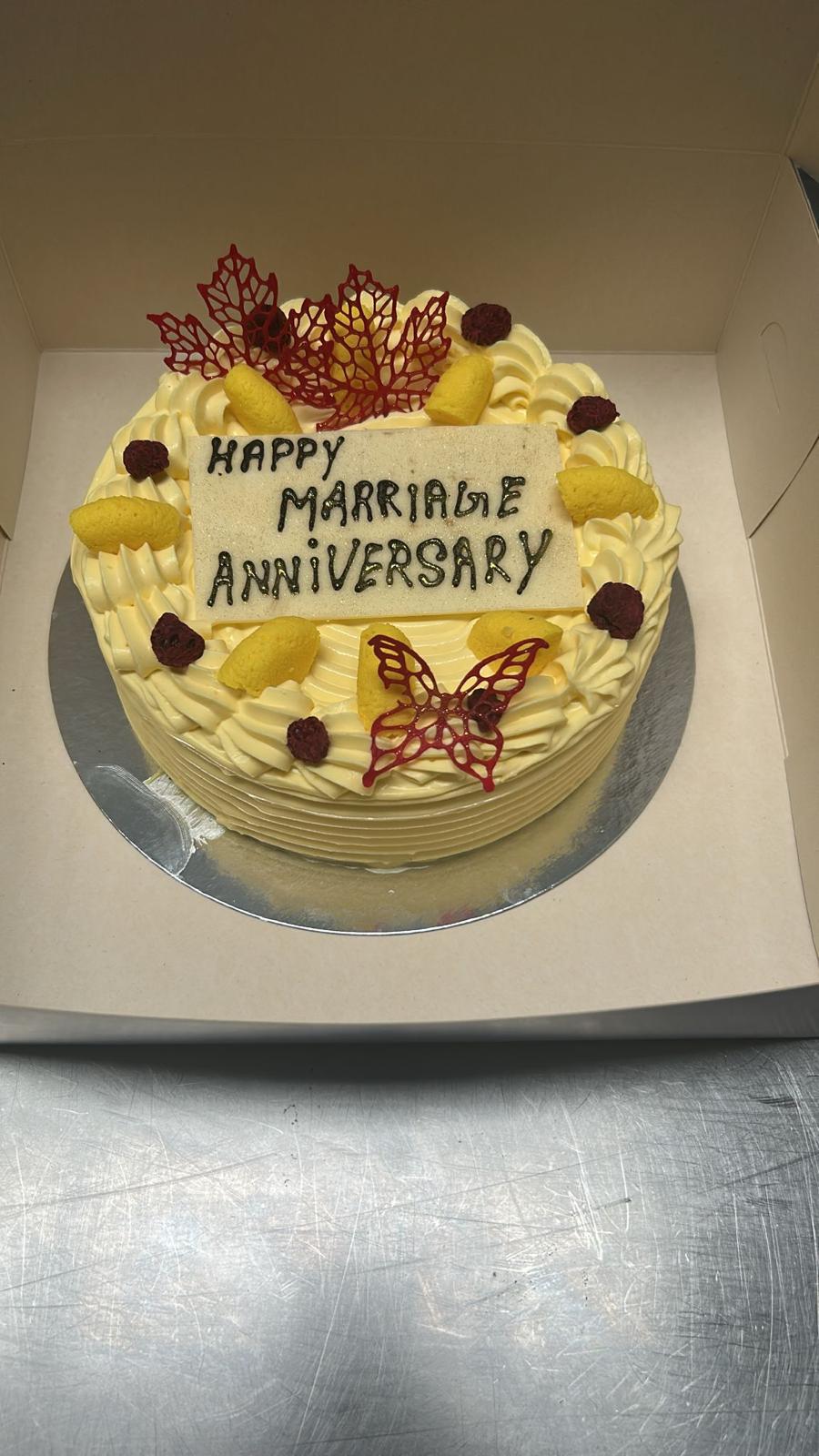 Marriage anniversary cream cake with berries and butterfly decoration
