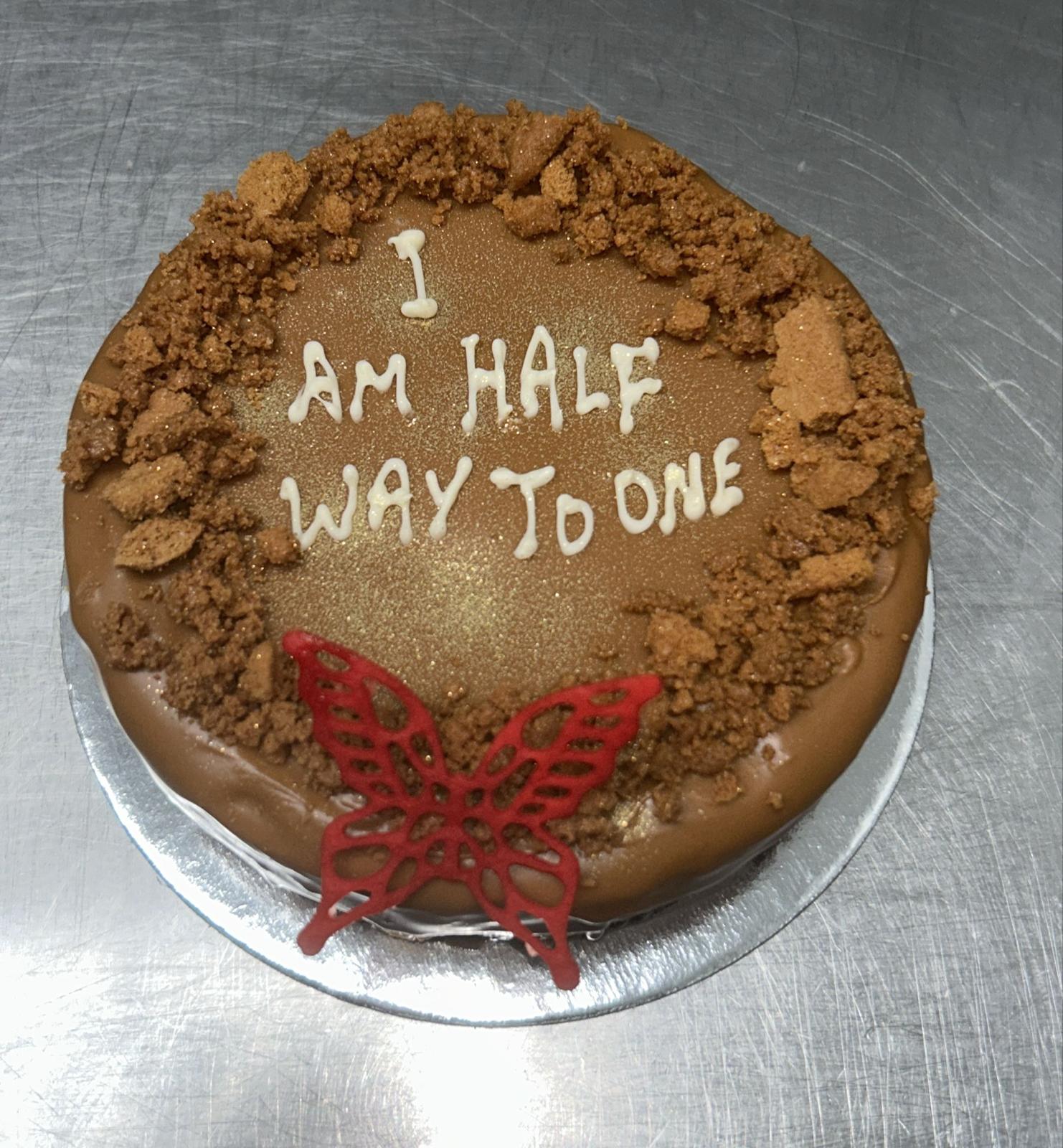 Lotus Biscoff crumb cake with red butterfly and cookie toppings